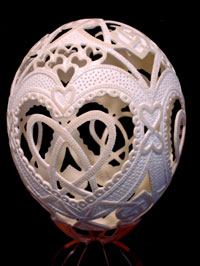 Tina writes, "A coworker and friend showed me an Ostrich egg one day that he had brought back from a hunting trip in Africa. It depicted carved elephants around the egg very roughly carved. It intrigued me so much that I bought a Dremel tool and sat down to work on aeggshell.  That was it, I was hooked!  This appeared to be the answer to my creativity needs.  It wasn't long before I invested in a high speed air tool and compressor, two Ostriches and many other types of birds to supply my eggs, and I was on my way."    