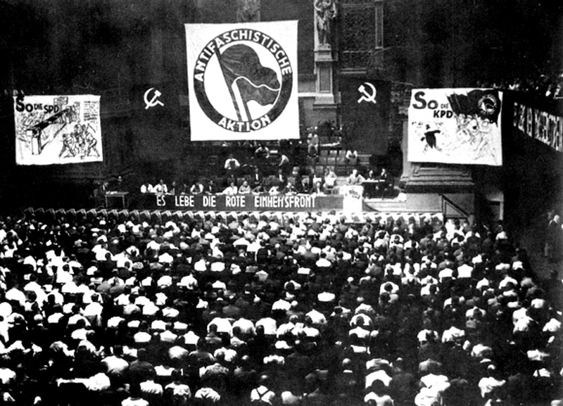 "These groups, oftentimes launched from the aforementioned housing estates, were generally called 'Antifaschistische Ausschüsse,' 'Antifaschistische Kommittees,' or the now famous 'Antifaschistische Aktion' – 'Antifa' for short. They drew on the slogans and orientation of the prewar united front strategy, adopting the word 'Antifa' from a last-ditch attempt to establish a cross-party alliance between Communist and Social Democratic workers in 1932. The alliance’s iconic logo, devised by Association of Revolutionary Visual Artists members Max Keilson and Max Gebhard, has been since become one of the Left’s most well-known symbols.:  Jacobin" 