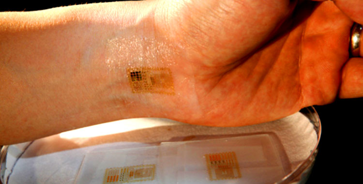 "The circuit bends, wrinkles and stretches with the mechanical properties of skin. The researchers demonstrated their concept through a diverse array of electronic components mounted on a thin, rubbery substrate, including sensors, LEDs, transistors, radio frequency capacitors, wireless antennas, and conductive coils and solar cells for power." - News Illinois Edu 