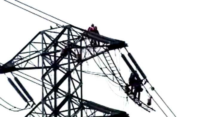 Linemen on a high-tension/high-voltage tower. Helicopter works as crane/truck/bus/taxi. PG & E crews (Pacific Gas and Electric) is the local utility. Quite an amazing job. By the way, we could hear them perfectly!  