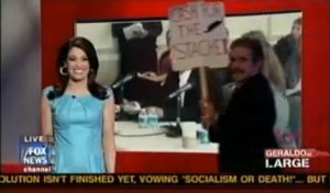 “Cash for Stash” Sign is carried across Set as Kimberly Guilfoyle laughs and laughs.  