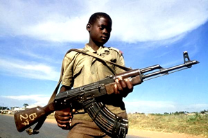  A child soldier of the LRA wields his Ak-47 assault rifle.  