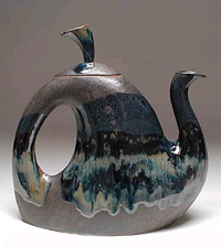 A Whimsical but functional teapot. Shown here in Black and Teal glaze. 