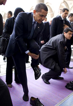 Obama President Obama removes his shoes before entering the Blue MosObama President Obama removes his shoes before entering the Blue Mosque, April 7, 2009.  