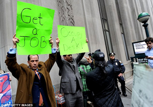 Derrick Tabacco, left, a small business owner, joins a small group counter-demonstrating against the Occupy Wall Street march near the New York Stock Exchange on Thursday.  